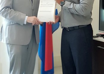 Minister Johnson presented with Summons booklet