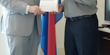 Minister Johnson presented with Summons booklet