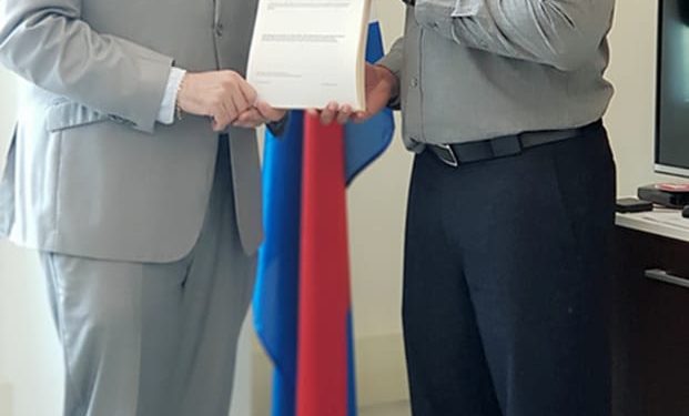 Minister Johnson presented with Summons booklet