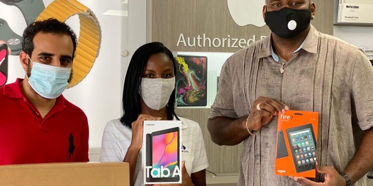 MP Omar Ottley along with others donates 63 electronic devices to allow students in need to participate in online learning.